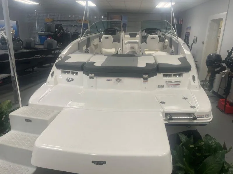 Slide: The Image of 2025 Chaparral 23 SSi boat in showroom, rear view with seating and swim platform. - 8