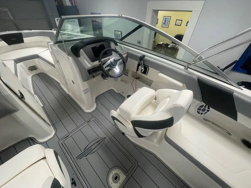 Slide: The Image of 2025 Chaparral 23 SSi boat interior with modern helm, seating, and sleek design. - 9