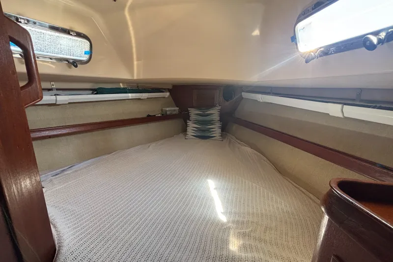 Slide: The Image of Cozy cabin interior of a 1995 Island Packet 37 sailboat with natural light. - 11