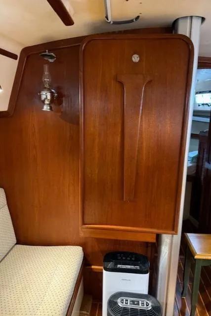 Slide: The Image of Interior of a 1995 Island Packet 37 sailboat with wooden paneling and seating. - 20