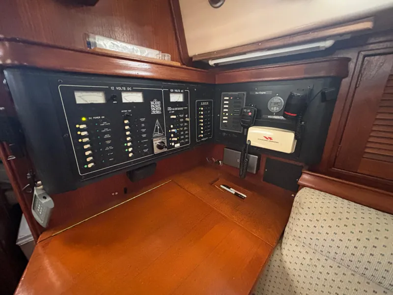 Slide: The Image of Control panel of a 1995 Island Packet 37 sailboat, featuring navigation and communication equipment. - 26