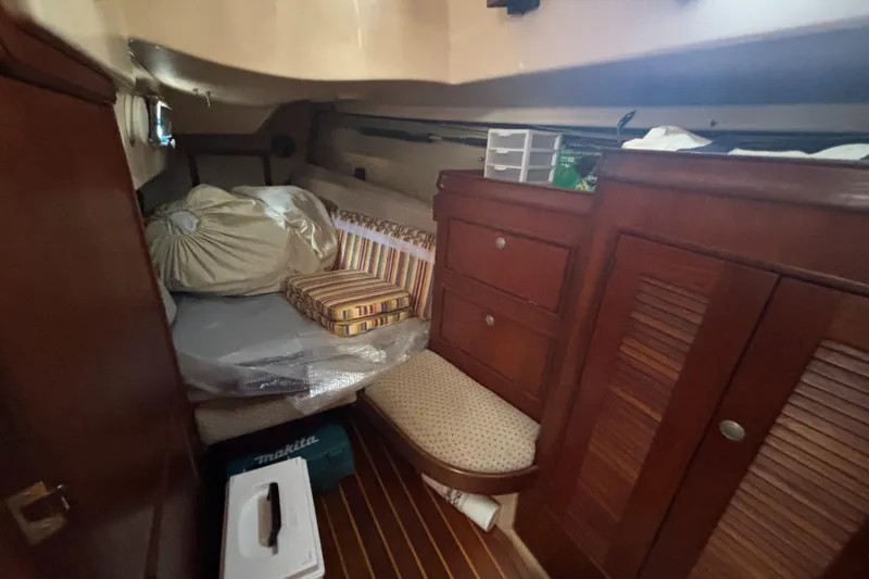 Slide: The Image of Cozy cabin interior of a 1995 Island Packet 37 sailboat with wooden furnishings. - 28
