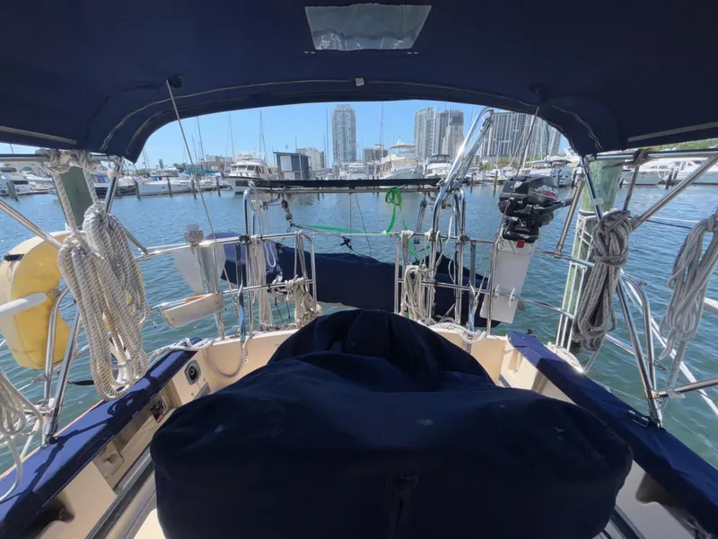 Slide: The Image of Cockpit view of 1995 Island Packet 37 sailboat docked in marina with city skyline. - 29