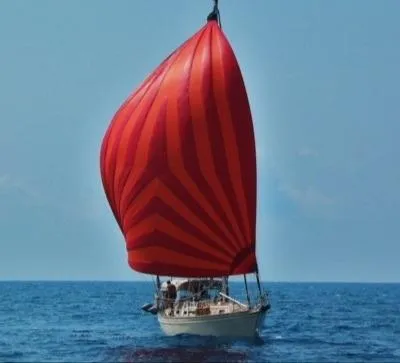 Slide: The Image of Cozy seating area on a 1995 Island Packet 37 sailboat with colorful striped cushions. - 6