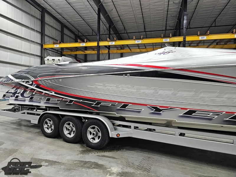 Slide: The Image of 2006 Outerlimits 46 Limited speedboat in storage, featuring sleek design and vibrant graphics. - 10