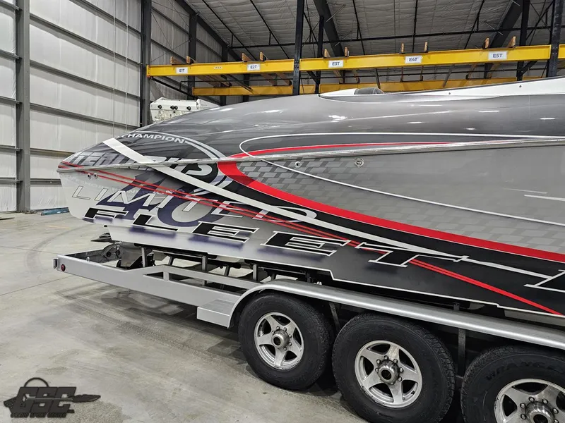 Slide: The Image of 2006 Outerlimits 46 Limited powerboat with bold graphics on a trailer in a warehouse. - 11