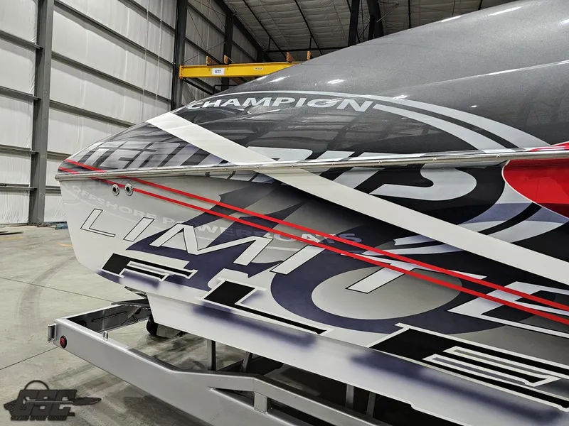 Slide: The Image of 2006 Outerlimits 46 Limited boat with bold graphics in a storage facility. - 13