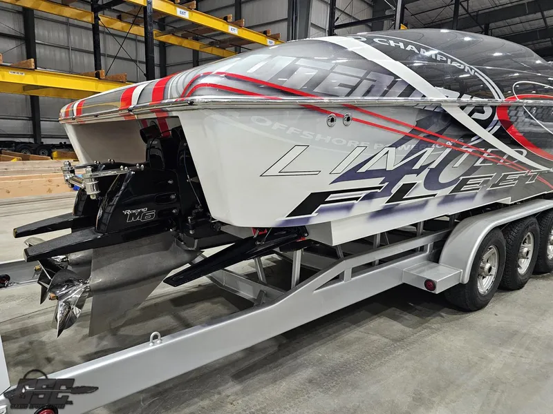 Slide: The Image of 2006 Outerlimits 46 Limited powerboat on trailer in warehouse setting. - 14