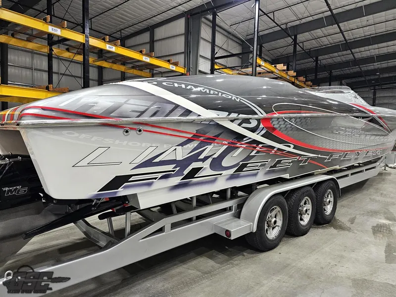 Slide: The Image of 2006 Outerlimits 46 Limited powerboat on trailer in warehouse setting. - 15