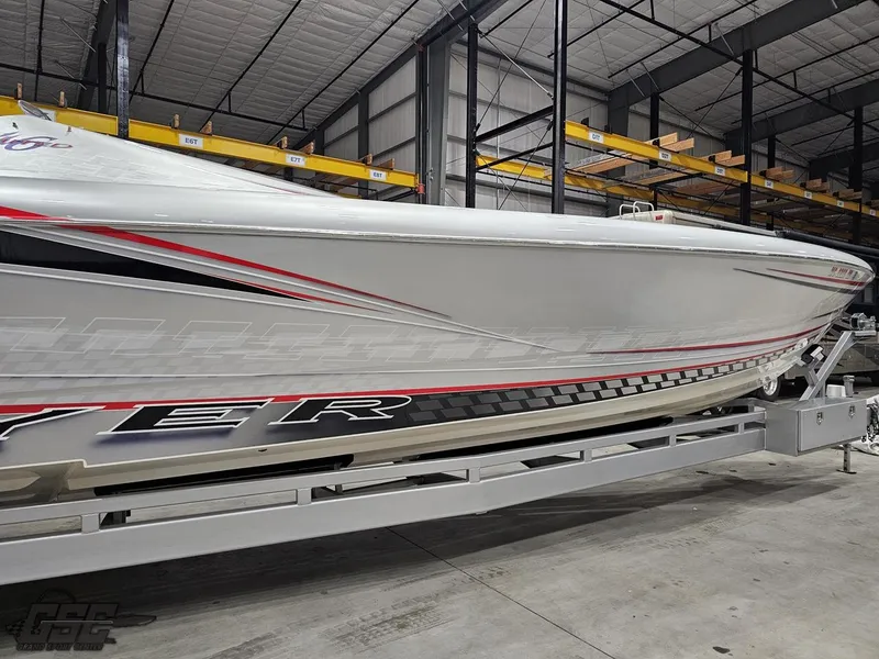 Slide: The Image of 2006 Outerlimits 46 Limited boat in storage, showcasing sleek design and vibrant graphics. - 18