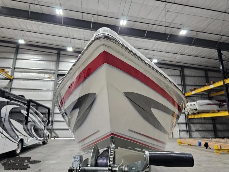 Slide: The Image of 2006 Outerlimits 46 Limited boat in storage, showcasing sleek design and vibrant red accents. - 21