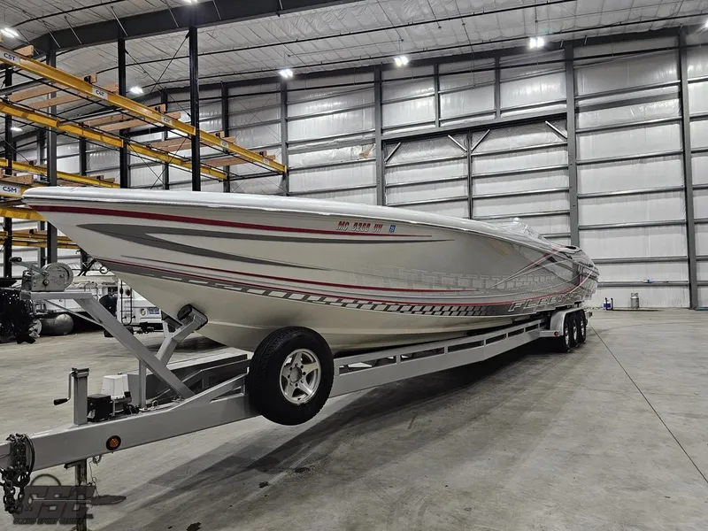Slide: The Image of 2006 Outerlimits 46 Limited speedboat on trailer in spacious indoor storage facility. - 22