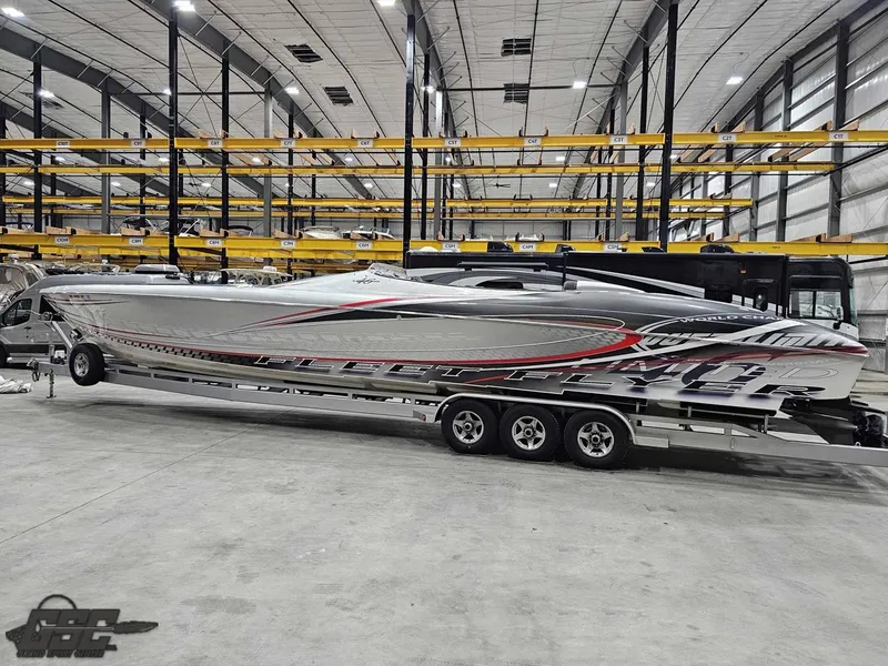 Slide: The Image of 2006 Outerlimits 46 Limited powerboat in storage facility, sleek design with red and gray accents. - 25