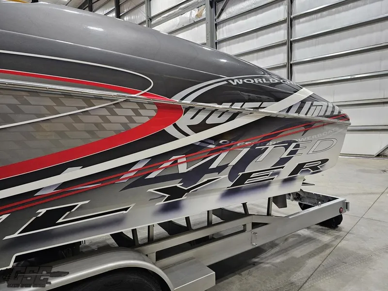 Slide: The Image of 2006 Outerlimits 46 Limited boat with sleek graphics in a storage facility. - 29