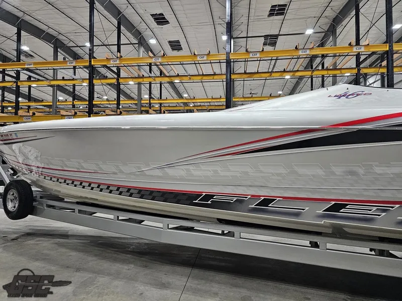 Slide: The Image of 2006 Outerlimits 46 Limited boat in warehouse, sleek design with red and black accents. - 30