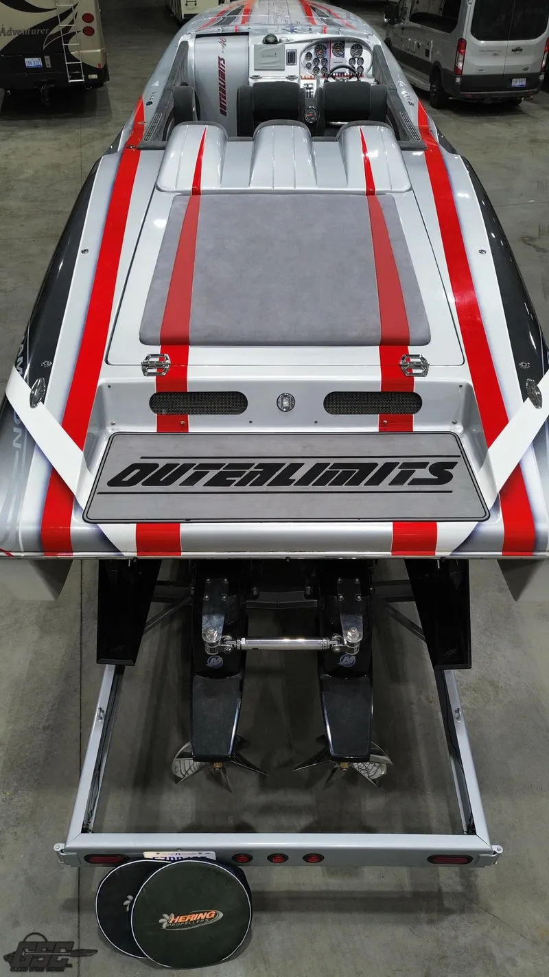 Slide: The Image of 2006 Outerlimits 46 Limited speedboat with red stripes, viewed from above in a garage. - 35