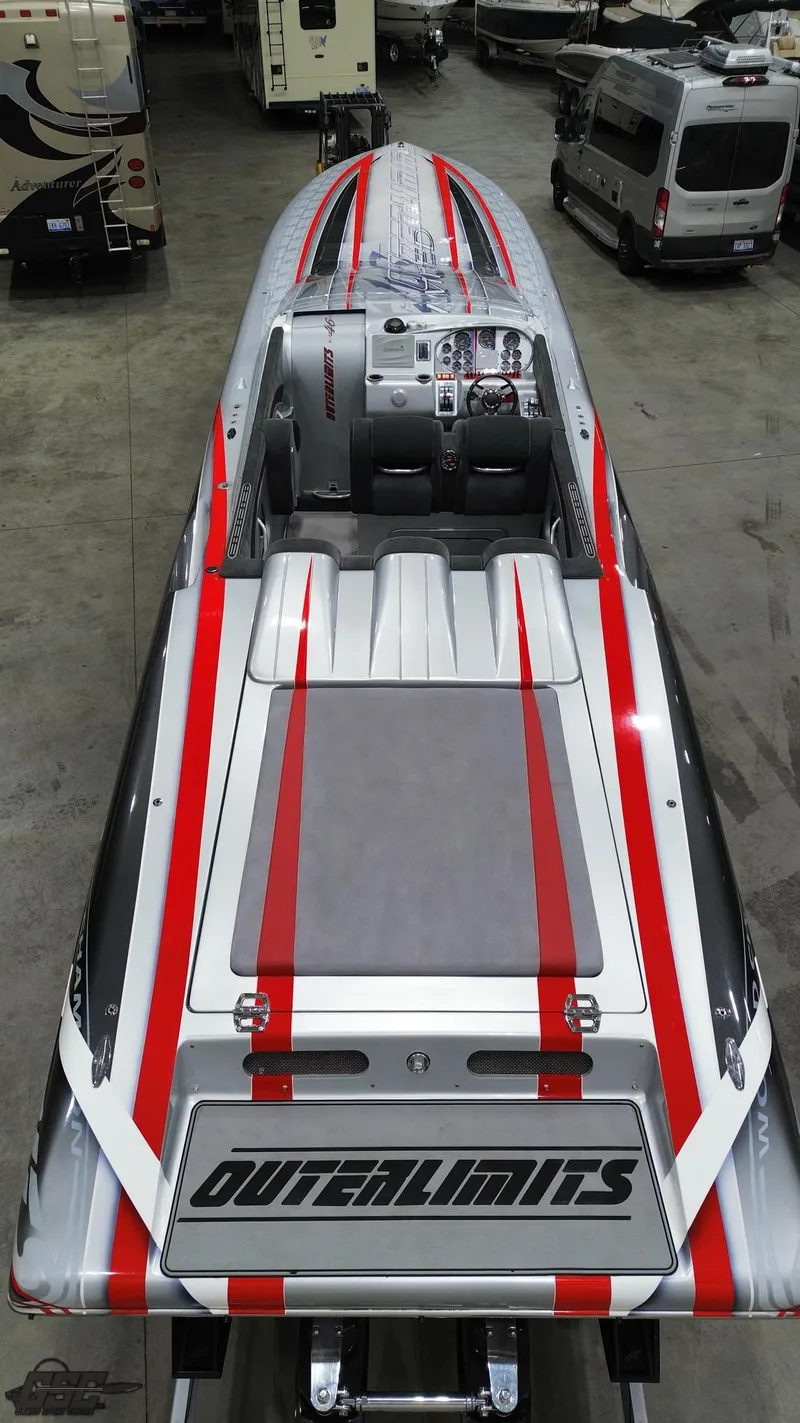 Slide: The Image of 2006 Outerlimits 46 Limited speedboat with sleek red and gray design in a showroom. - 36