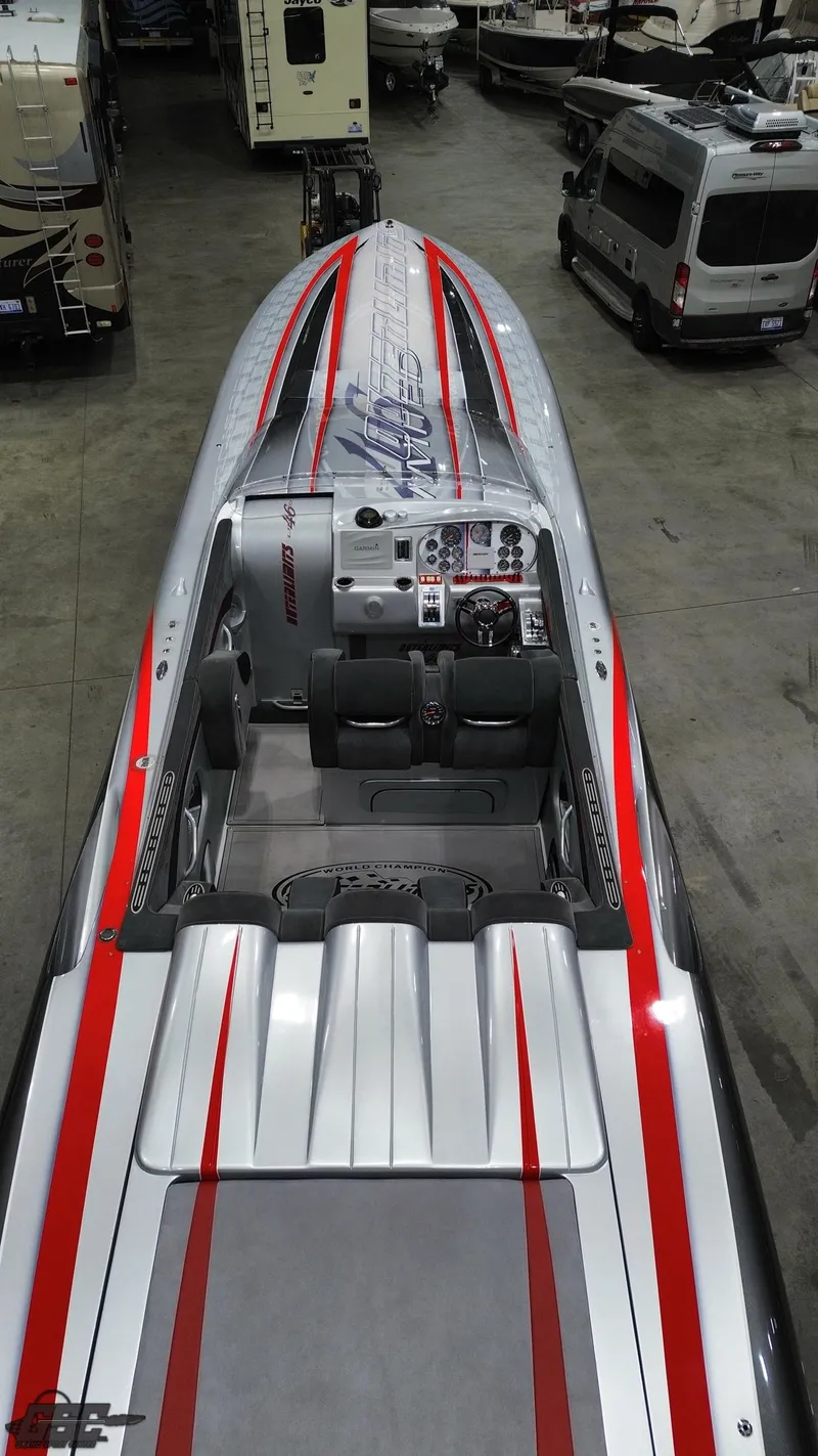 Slide: The Image of 2006 Outerlimits 46 Limited speedboat with sleek design and red accents in a showroom. - 37