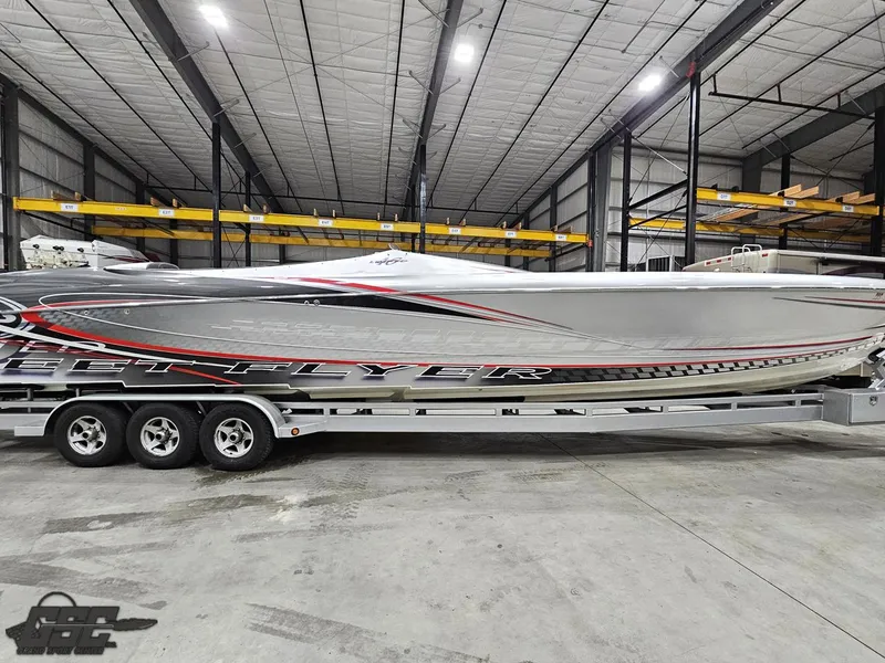 Slide: The Image of 2006 Outerlimits 46 Limited speedboat in warehouse, sleek design on trailer. - 4