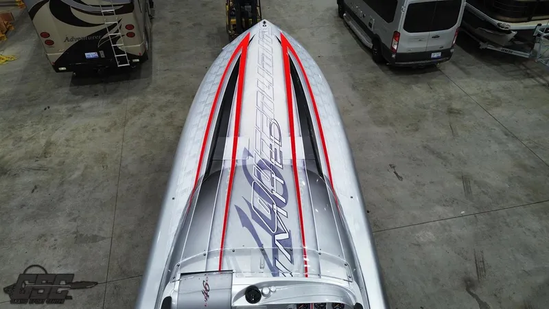 Slide: The Image of 2006 Outerlimits 46 Limited speedboat with sleek silver and red design in a garage. - 44