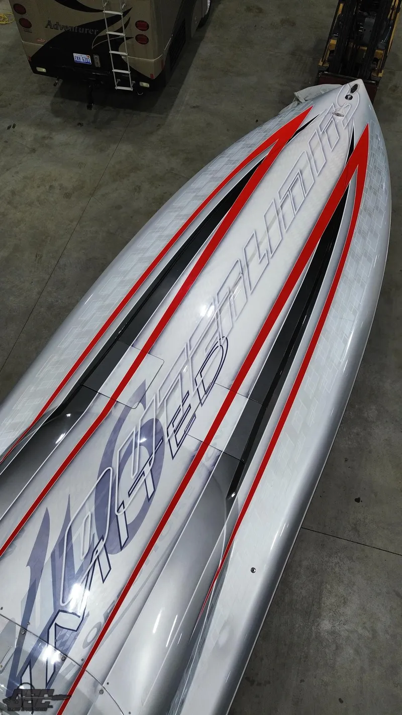 Slide: The Image of 2006 Outerlimits 46 Limited boat with sleek design and bold graphics in a showroom. - 45