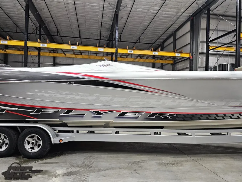 Slide: The Image of 2006 Outerlimits 46 Limited powerboat in storage, featuring sleek design and vibrant graphics. - 5