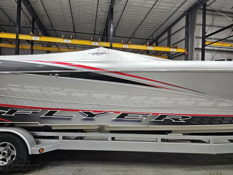 Slide: The Image of 2006 Outerlimits 46 Limited boat in storage, featuring sleek design and bold graphics. - 6
