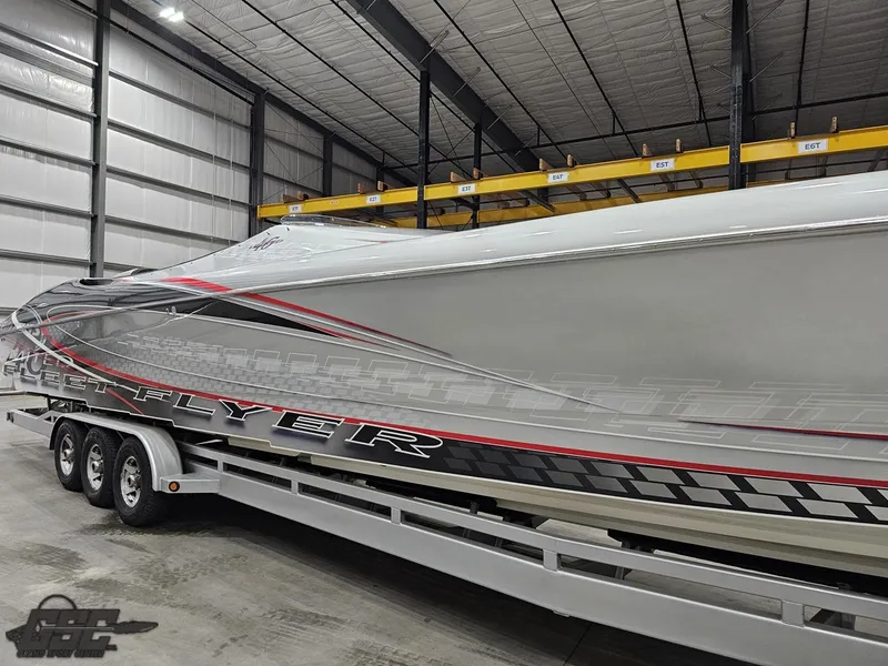 Slide: The Image of 2006 Outerlimits 46 Limited powerboat on trailer in warehouse setting. - 8