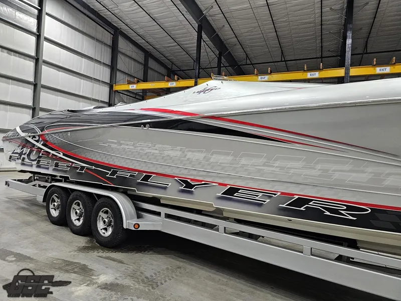 Slide: The Image of 2006 Outerlimits 46 Limited speedboat in storage, featuring sleek design and vibrant graphics. - 9