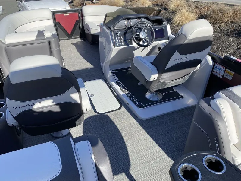 Slide: The Image of 2024 Viaggio Diamante D22U Triple pontoon boat interior with modern seating and steering console. - 17