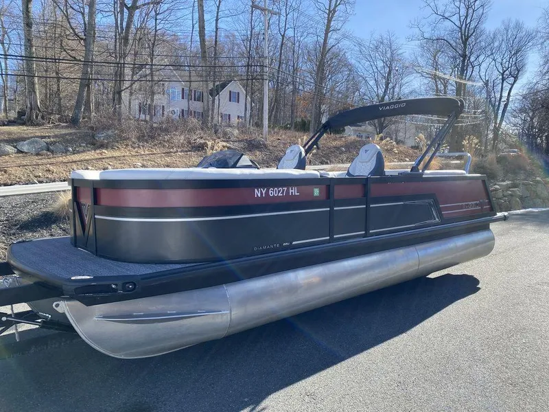 Slide: The Image of 2024 Viaggio Diamante D22U Triple pontoon boat parked on a sunny day. - 6