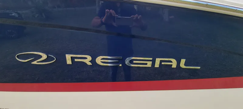 Slide: The Image of 2021 Regal LS2 boat with logo on blue and white hull. - 10