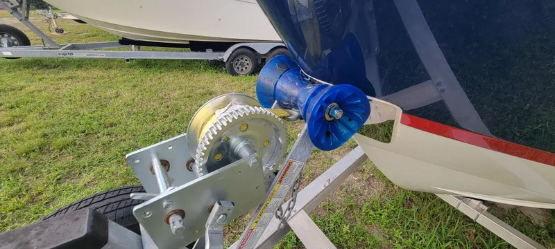 Slide: The Image of Boat trailer with winch and Regal LS2, 2021 model, on grassy area. - 11