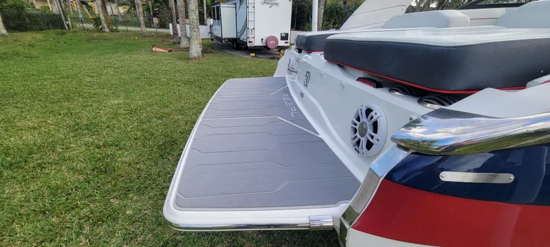 Slide: The Image of 2021 Regal LS2 boat with swim platform on grassy area. - 15