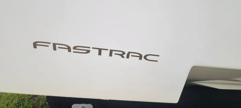 Slide: The Image of 2021 Regal LS2 boat with "FASTRAC" logo on white surface. - 26