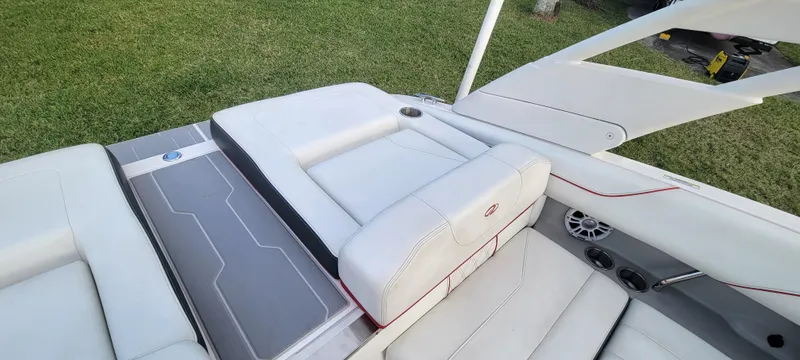 Slide: The Image of 2021 Regal LS2 boat interior with white seating and speaker system. - 28