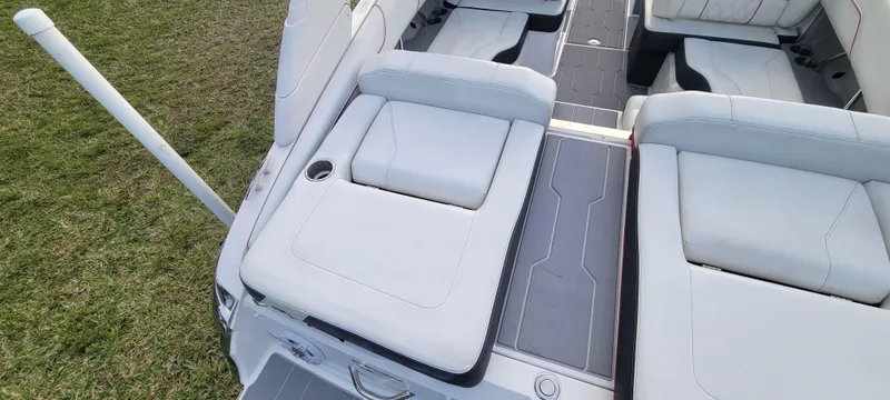 Slide: The Image of 2021 Regal LS2 boat interior with white cushioned seating and sleek design. - 31