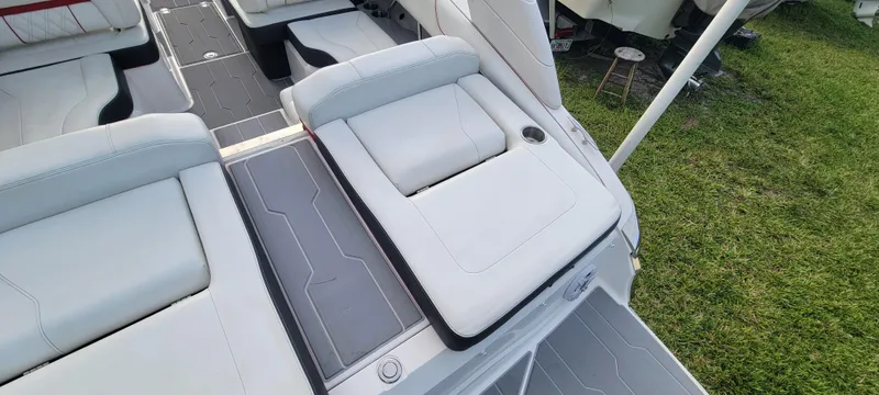 Slide: The Image of 2021 Regal LS2 boat interior with sleek, modern seating and gray flooring. - 32