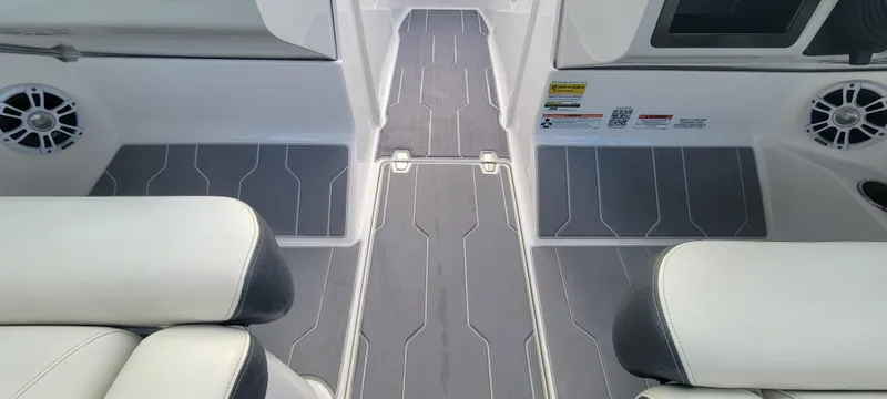 Slide: The Image of Interior view of a 2021 Regal LS2 boat, featuring sleek seating and modern flooring. - 35