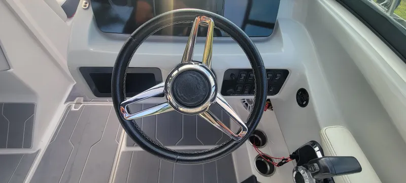 Slide: The Image of Steering wheel of a 2021 Regal LS2 boat, featuring a sleek, modern dashboard design. - 45