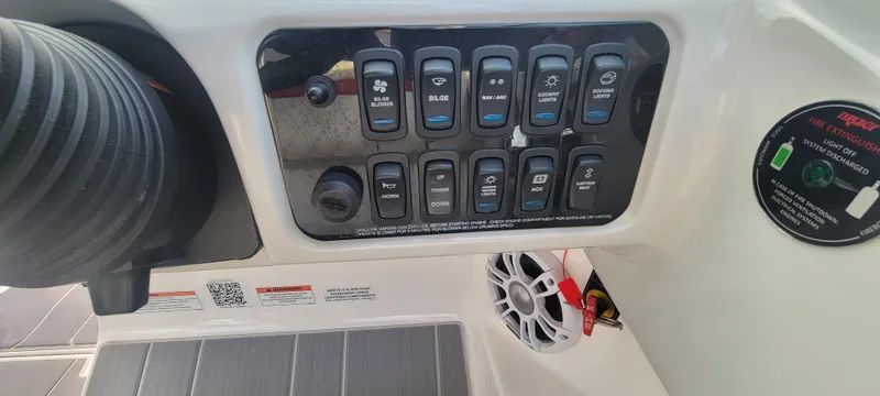 Slide: The Image of Control panel of a 2021 Regal LS2 boat with various switches and speaker. - 47