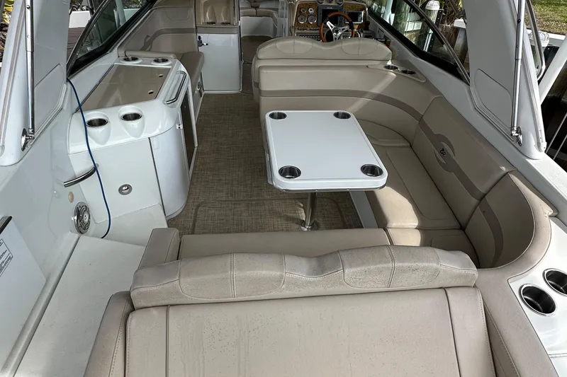 Slide: The Image of 2009 Formula 310 Bowrider interior with seating, table, and kitchenette. - 11