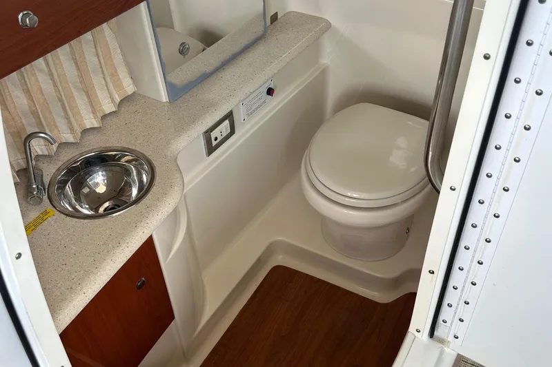 Slide: The Image of 2009 Formula 310 Bowrider bathroom with sink, toilet, and wood accents. - 12