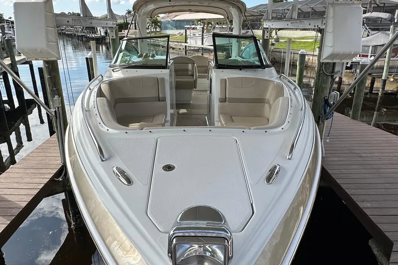 Slide: The Image of 2009 Formula 310 Bowrider boat docked, featuring spacious seating and sleek design. - 6