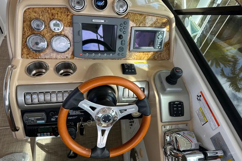 Slide: The Image of 2009 Formula 310 Bowrider dashboard with wood steering wheel and navigation instruments. - 9
