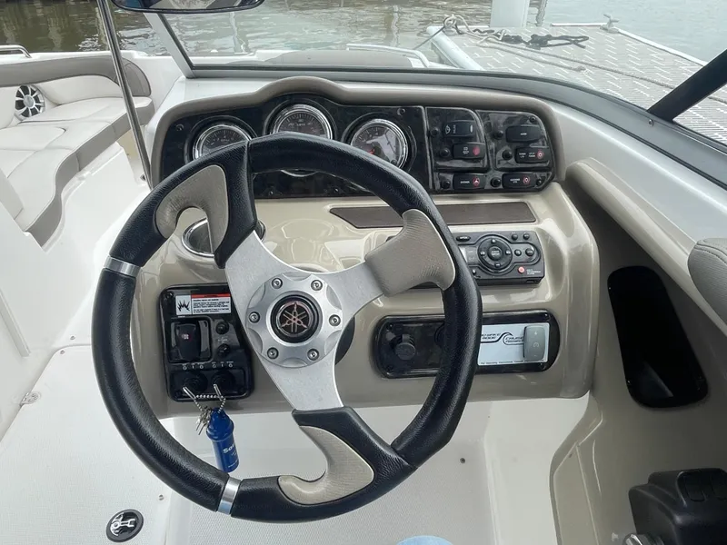 Slide: The Image of 2020 Yamaha Boats 242 Limited S dashboard with steering wheel and controls. - 11