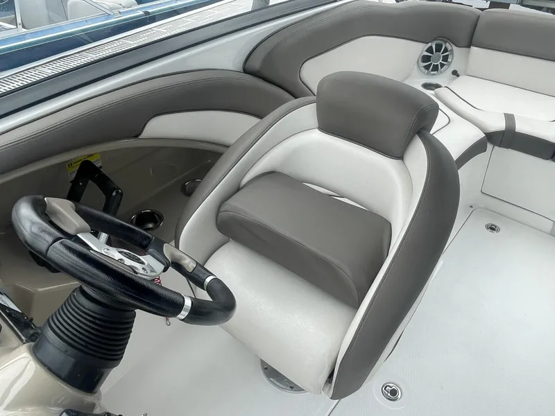 Slide: The Image of 2020 Yamaha Boats 242 Limited S interior with steering wheel and cushioned seating. - 15