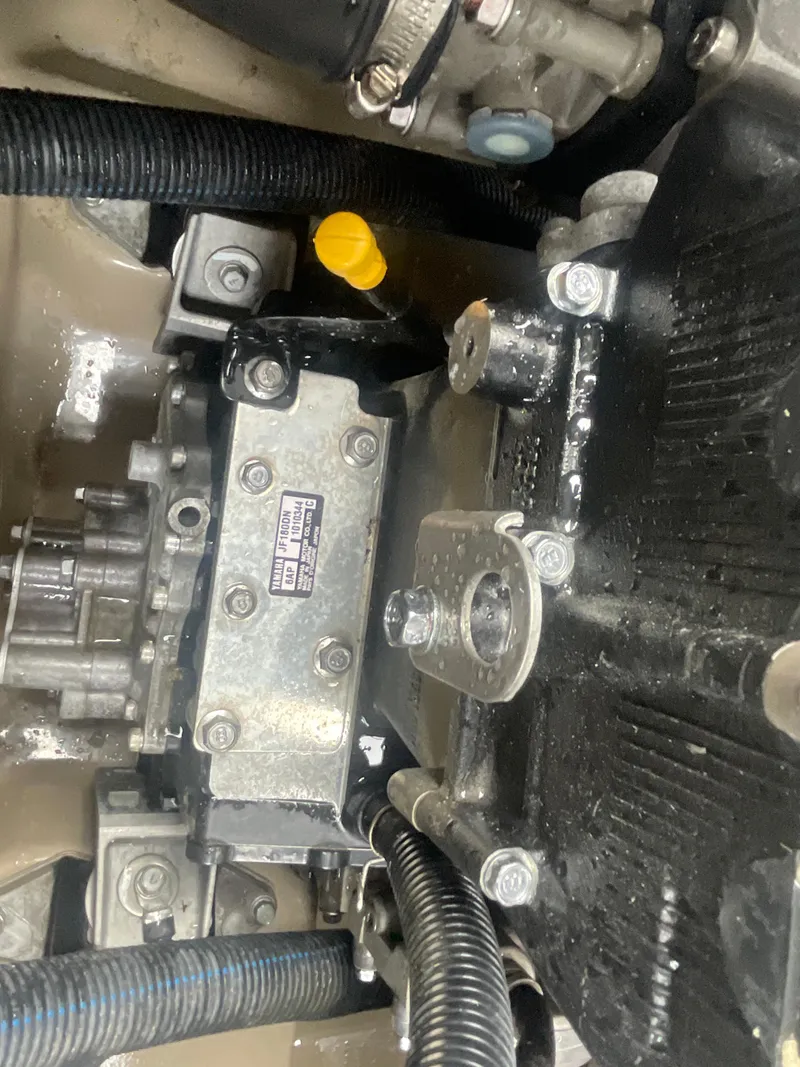 Slide: The Image of 2020 Yamaha Boats 242 Limited S engine compartment, showcasing mechanical components and wiring. - 18