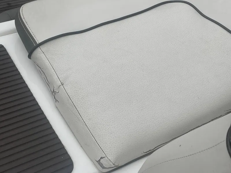 Slide: The Image of Worn seat cushion on 2020 Yamaha Boats 242 Limited S, showing visible cracks and wear. - 21
