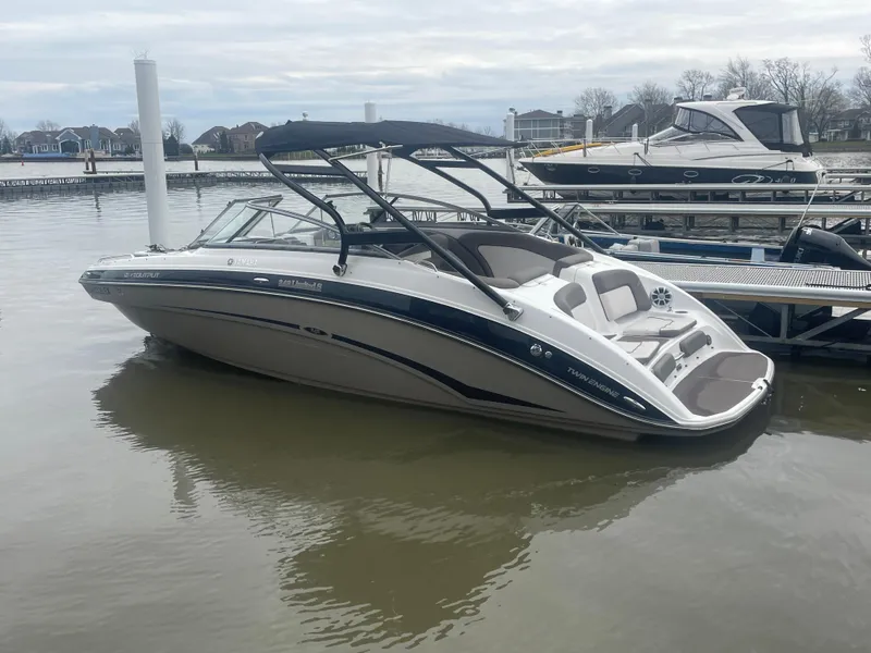 Slide: The Image of 2020 Yamaha Boats 242 Limited S docked on calm water. - 23